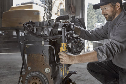 Dewalt DCF510N Akku-Ratsche wird von einem Mechaniker an einem Motorblock verwendet